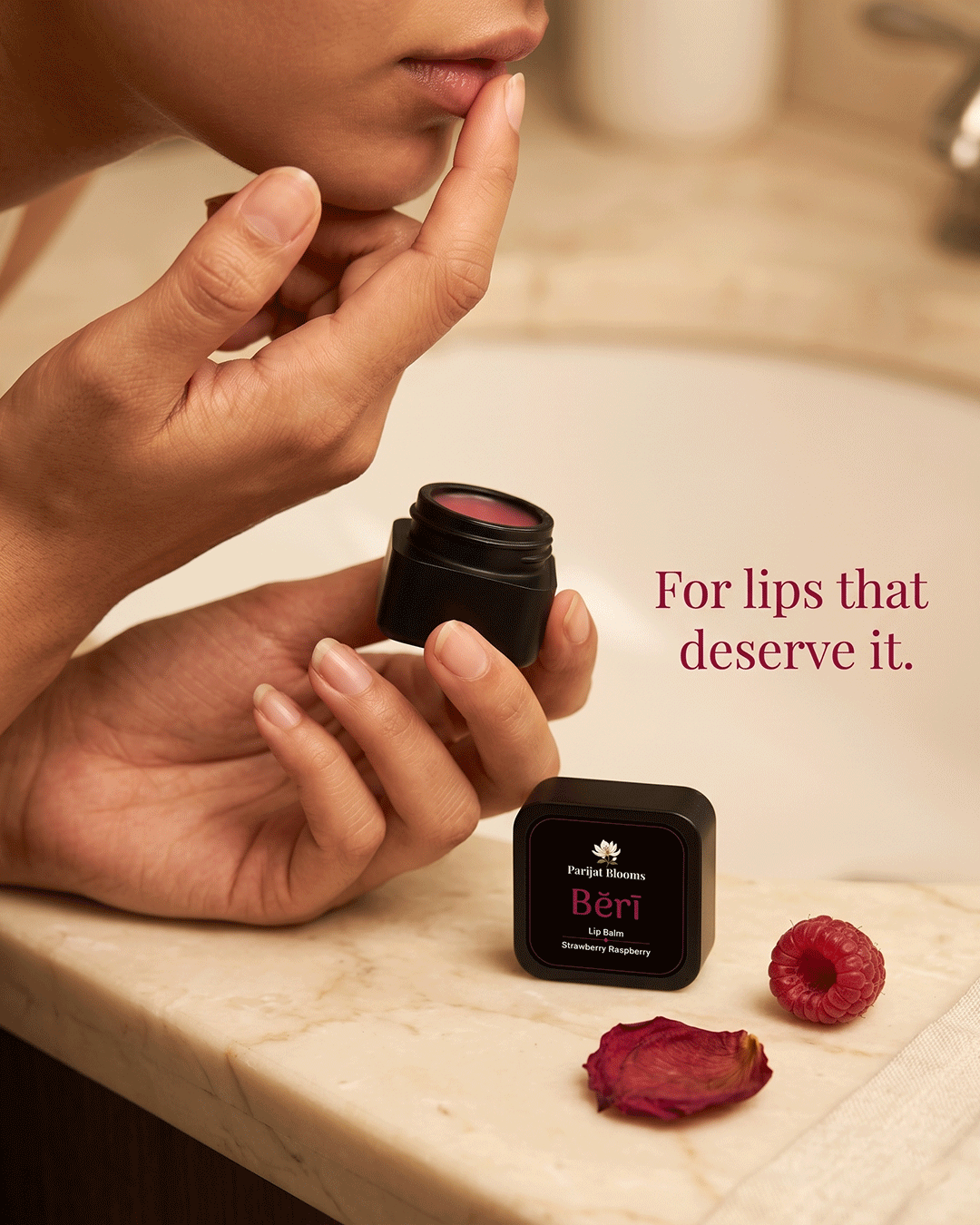 Beri Raspberry Strawberry Lip Balm Ayurvedic ritual lip balm in use — hand holding lip balm Parijat Blooms India