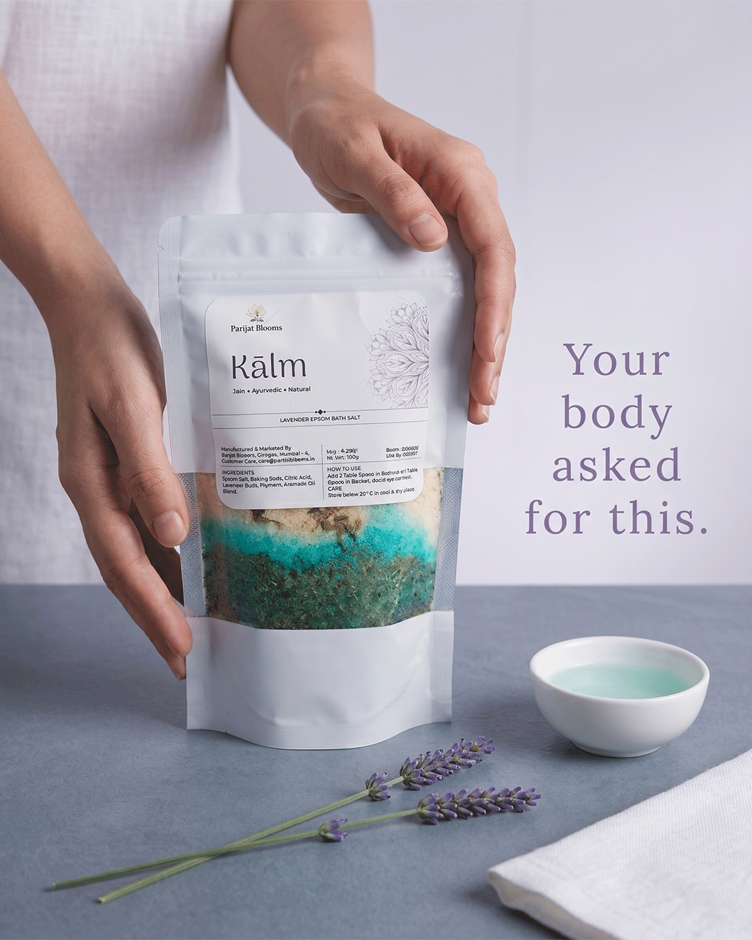 Kalm Lavender Epsom Bath Salt Ayurvedic ritual bath salt in use — hand holding bath salt Parijat Blooms India