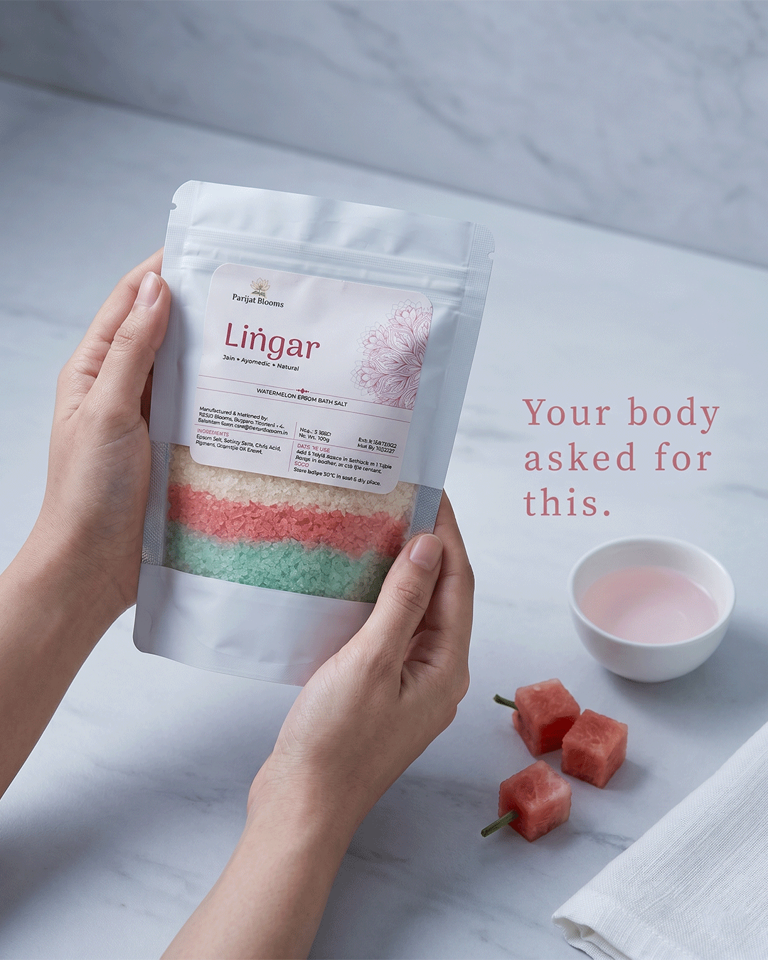Lingar Watermelon Epsom Bath Salt Ayurvedic ritual bath salt in use — hand holding bath salt Parijat Blooms India