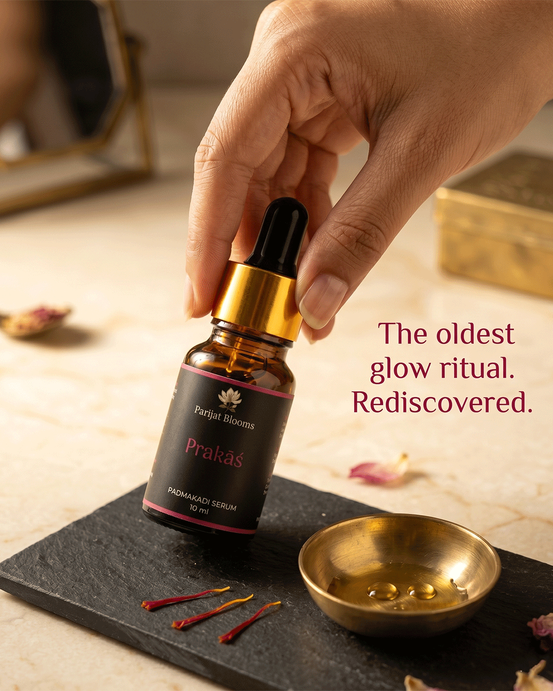 Prakas Padmakadi Kumkumadi Nalpamaradi Face Serum Ayurvedic ritual face serum in use — hand holding face serum Parijat Blooms India