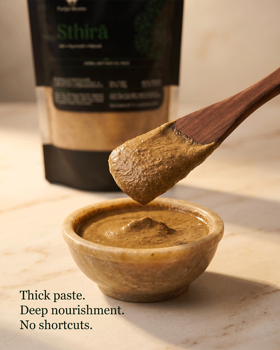 Sthirā herbal paste texture closeup — thick nourishing anti hair fall mask Parijat Blooms