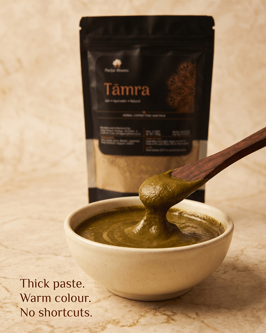 Tāmra copper-brown herbal paste texture closeup — natural grey hair coverage mask Parijat Blooms